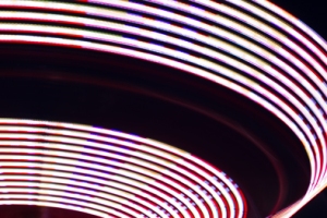 This is an image taken of a ride at a local carnival.  The curve in the line here directs your eye across the image. The use of a slow shutter speed also contributes to this I think.